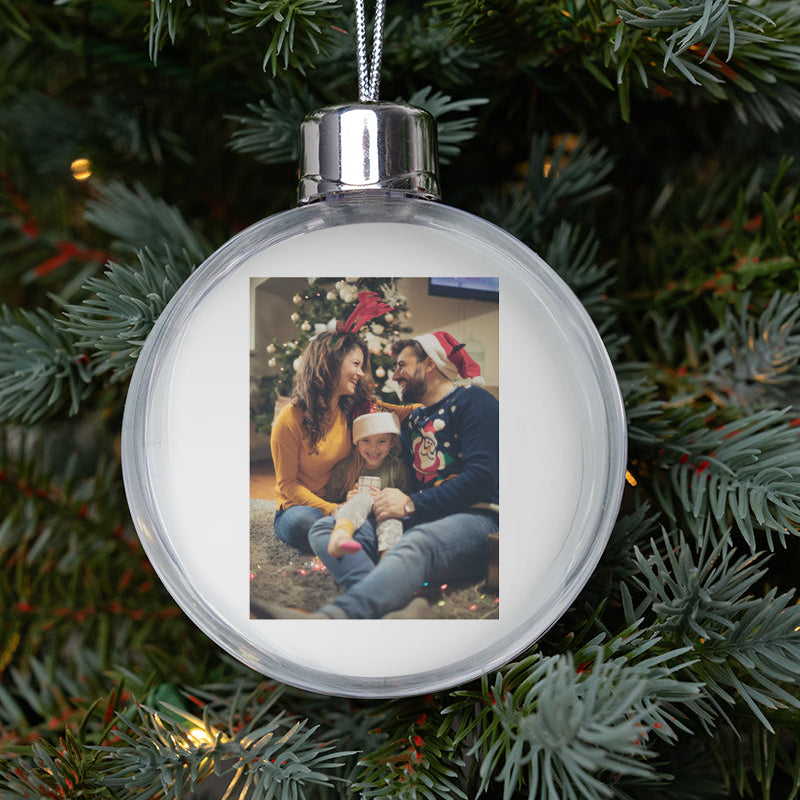 Round Christmas ornament with a family photo on a tree