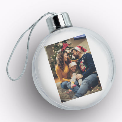 Round glass ornament with a family photo on a white background