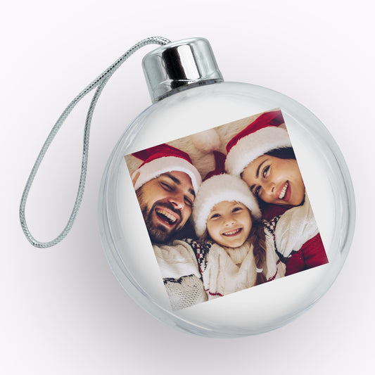 Round Christmas ornament with a family photo on a white background