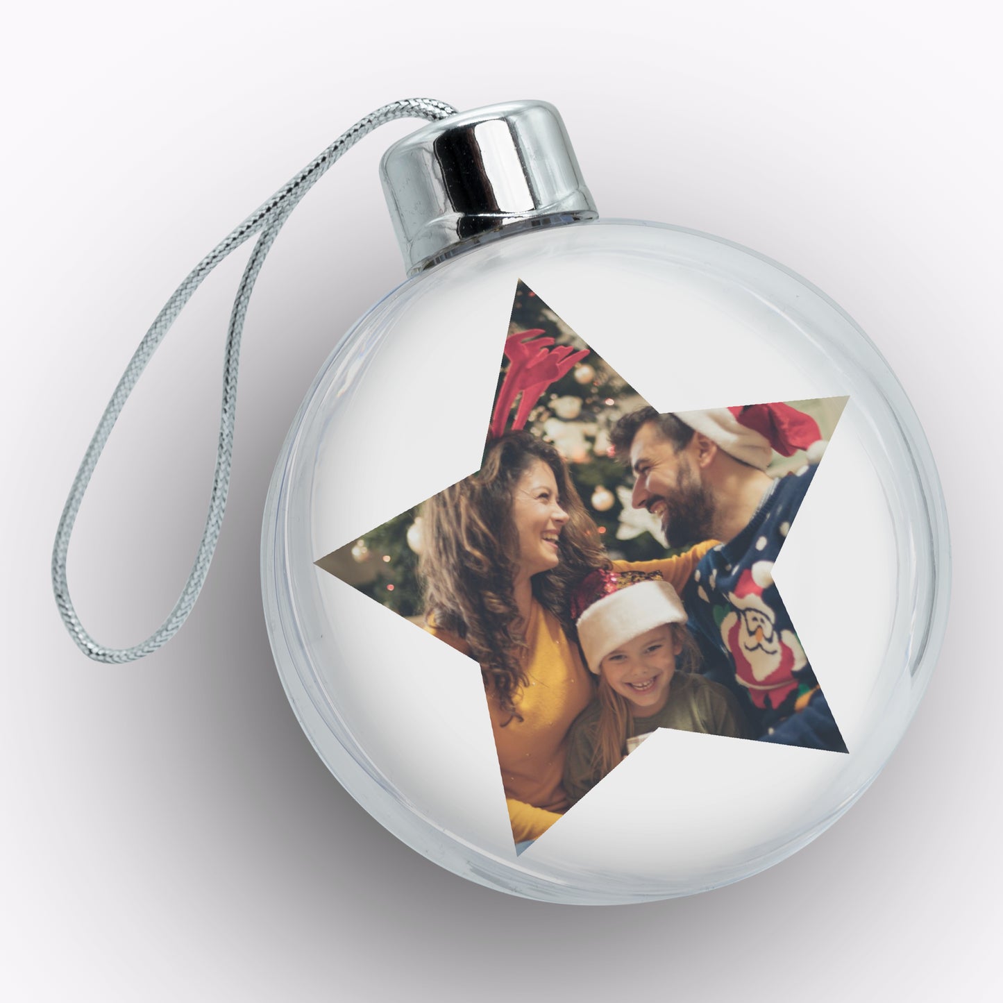 Clear Christmas ornament with star-shaped cutout featuring a family photo on a white background