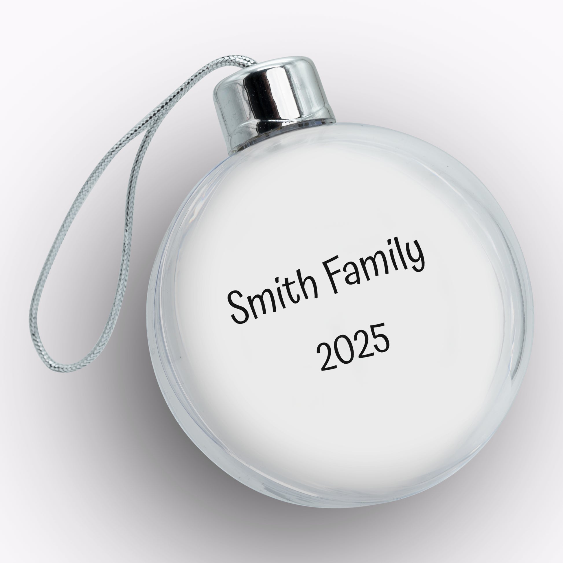 Round white ornament with 'Smith Family 2025' text on a light gray background